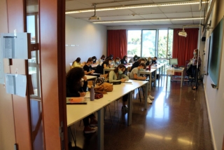 Imatge d&#039;una aula de la URV, vista des de fora, amb alumnes fent classe amb mascareta en el primer dia del curs 2020-2021