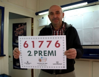 El propietari de l&#039;administració número dos del Vendrell amb el cartell del segon premi del sorteig del Nen