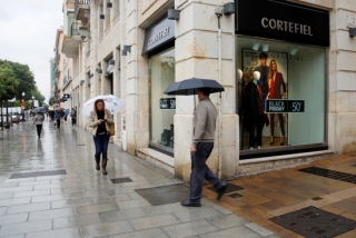 La Rambla Nova amb el carrer Comte de Rius de Tarragona amb diverses persones passejant entre botigues que mostren la promoció del Black Friday