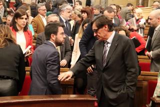 El líder del PSC, Salvador Illa, toca el braç del president de la Generalitat, Pere Aragonès, en una sessió parlamentària 