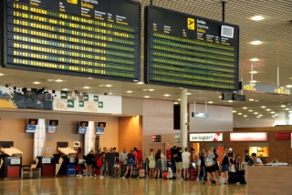 Pantalla indicant un retard en un vol de Ryanair a Frankfurt i cues de fons a l&#039;Aeroport de Reus