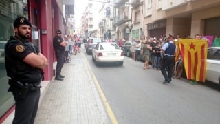 Agents de la guàrdia civil custodiant la seu del setmanari El Vallenc davant les protestes de ciutadans